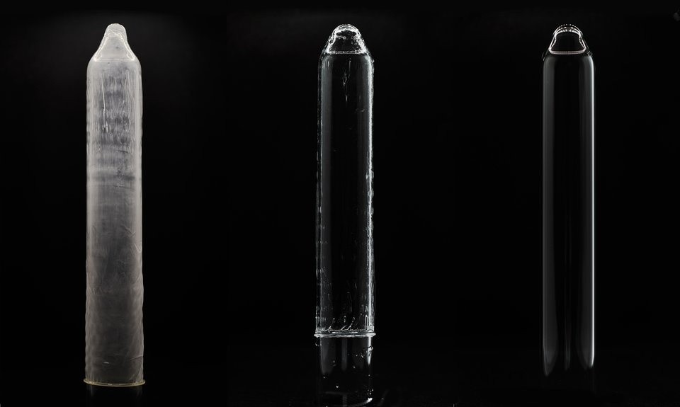Three glass mandrels showing a latex condom, the Eudaemon hydrogel condom and a bare mandrel